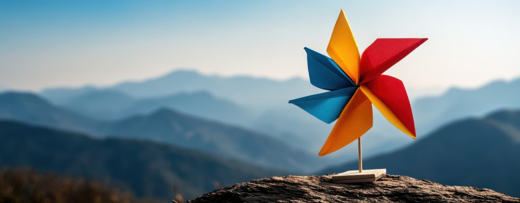 a vibrant paper pinwheel spins freely atop a majestic mountain ridge, showcasing a breathtaking panoramic vista of rolling hills under a clear sky, reminiscent of a giant zo